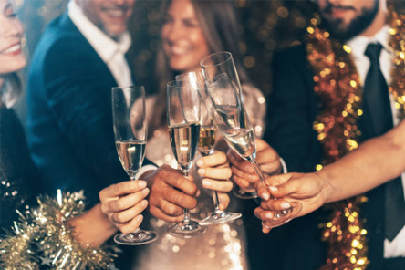 Celebration party with guests raising glasses